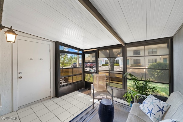 sunroom with beamed ceiling and a wealth of natural light