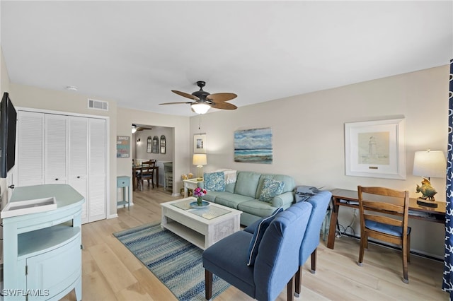 living room with ceiling fan and light hardwood / wood-style floors