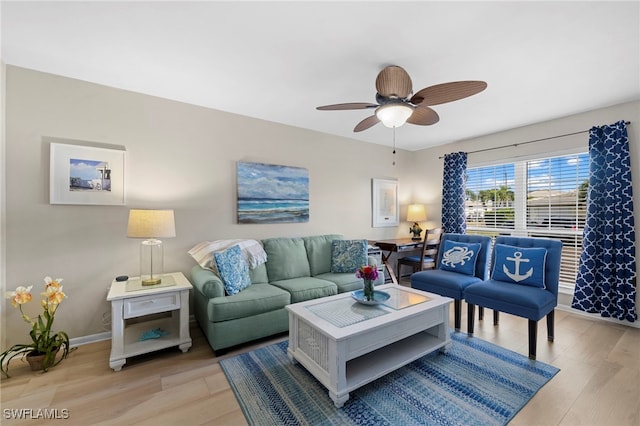 living room featuring light hardwood / wood-style floors and ceiling fan