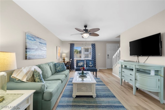 living room with ceiling fan and light hardwood / wood-style flooring