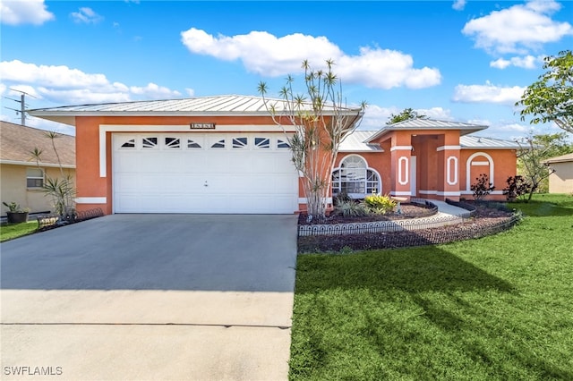 view of front of house with a front lawn and a garage