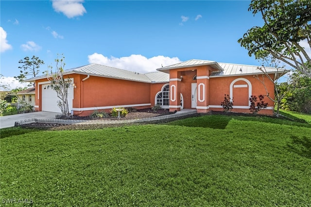 view of front of property featuring a front lawn and a garage