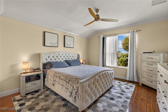 bedroom featuring dark wood-style floors, baseboards, visible vents, and crown molding