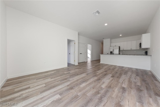 unfurnished living room featuring light hardwood / wood-style flooring