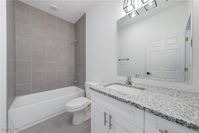 full bathroom with tile patterned floors, toilet, vanity, and tiled shower / bath combo