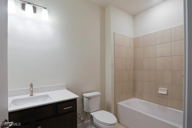 full bathroom with vanity, tiled shower / bath, and toilet