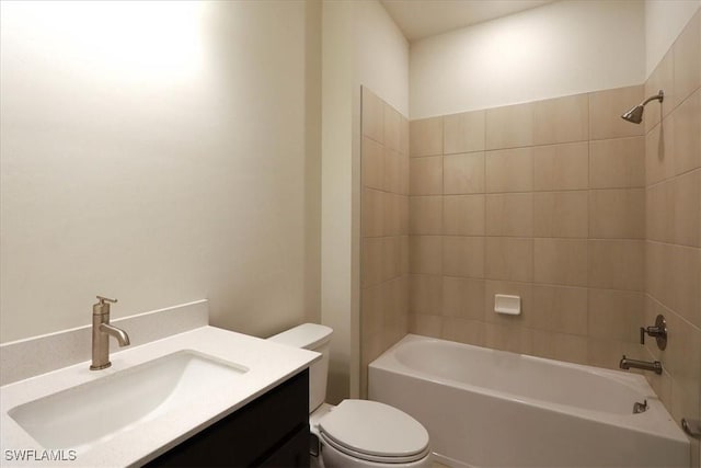 full bathroom featuring tiled shower / bath combo, vanity, and toilet