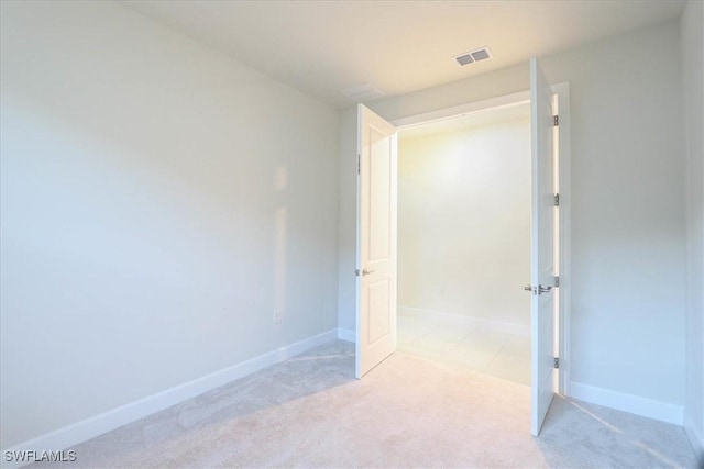 unfurnished bedroom featuring light colored carpet