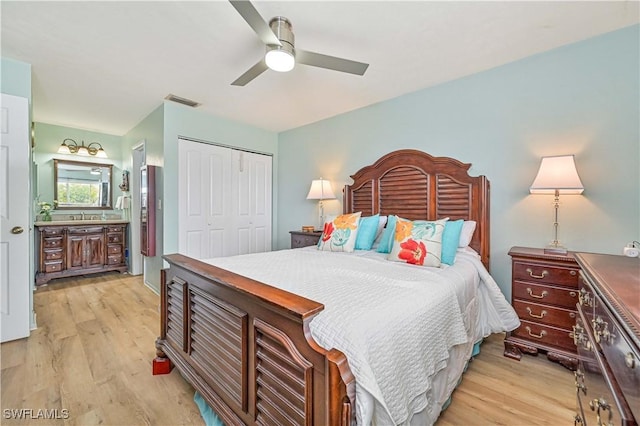 bedroom with visible vents, a closet, light wood-style flooring, and a ceiling fan