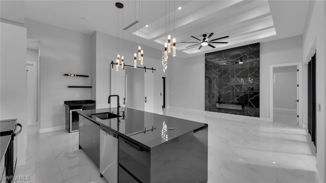 kitchen featuring a large island, modern cabinets, a raised ceiling, and a sink