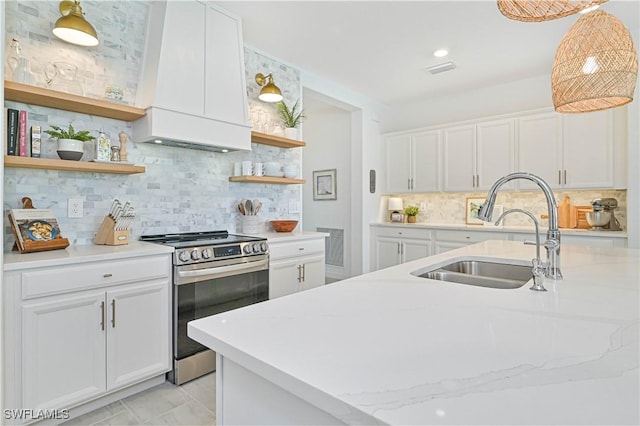 kitchen featuring pendant lighting, electric stove, open shelves, white cabinets, and a sink