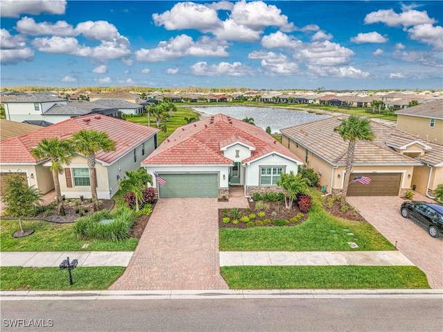 view of front facade with decorative driveway, stucco siding, a garage, a residential view, and a tiled roof