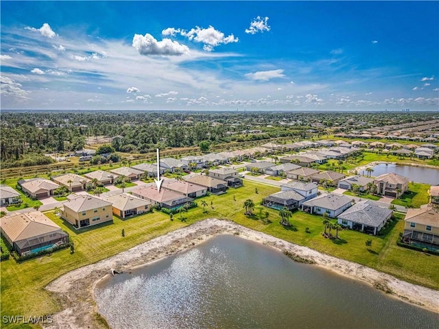 drone / aerial view featuring a water view and a residential view