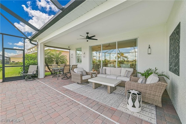 sunroom with beam ceiling and a ceiling fan