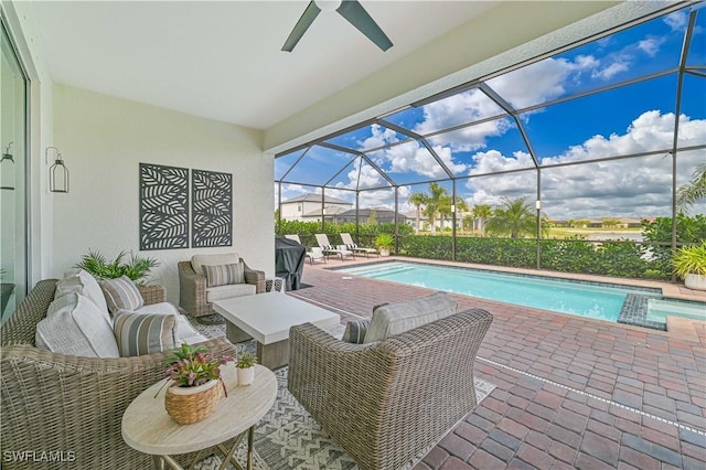 outdoor pool with a lanai, outdoor lounge area, and a patio