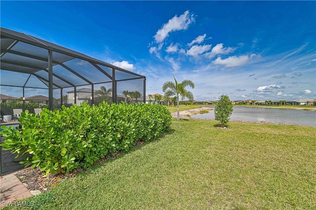 view of yard featuring glass enclosure and a water view