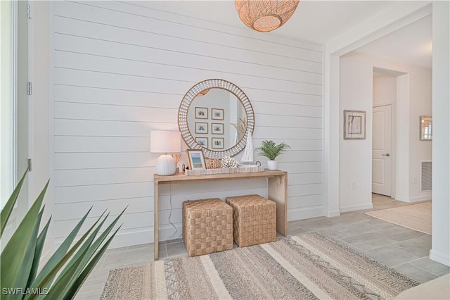 corridor with baseboards and visible vents