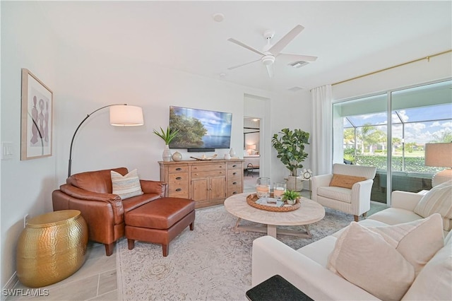 living room with visible vents, a ceiling fan, and light tile patterned flooring