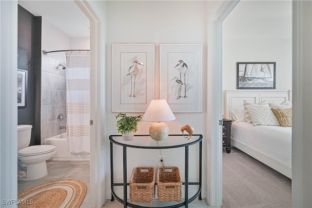 bedroom featuring light carpet and ensuite bath