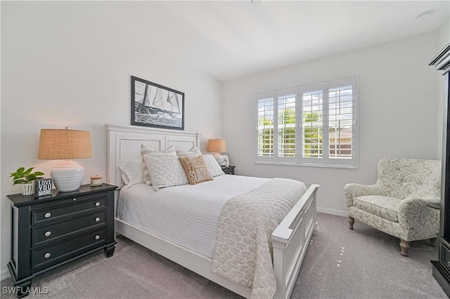 bedroom featuring baseboards and dark carpet