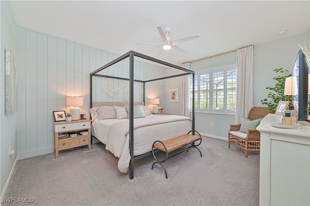 bedroom featuring light carpet, ceiling fan, and baseboards