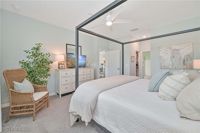 bedroom featuring baseboards, visible vents, a ceiling fan, light colored carpet, and ensuite bathroom