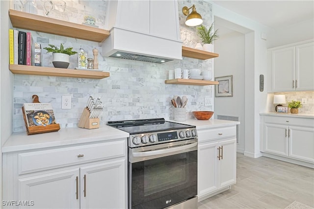 kitchen with white cabinets, open shelves, stainless steel electric stove, and light countertops