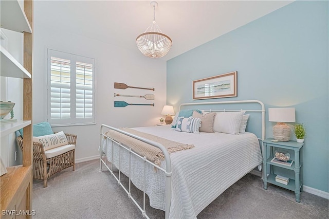 carpeted bedroom with baseboards and an inviting chandelier