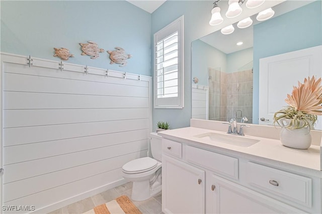 full bath with toilet, a shower stall, and vanity