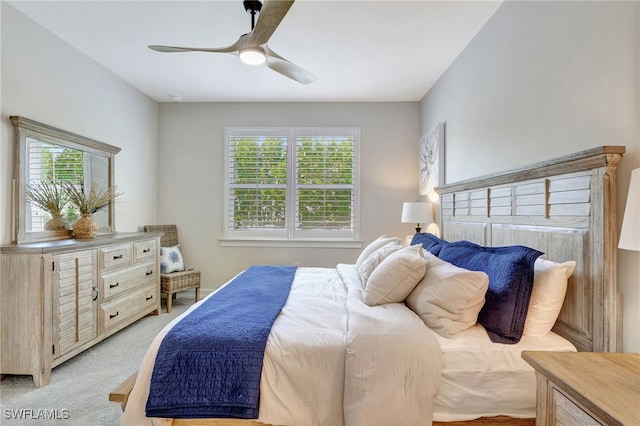 bedroom featuring light colored carpet and ceiling fan