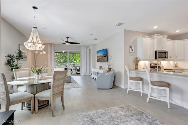 dining space featuring light hardwood / wood-style floors and ceiling fan