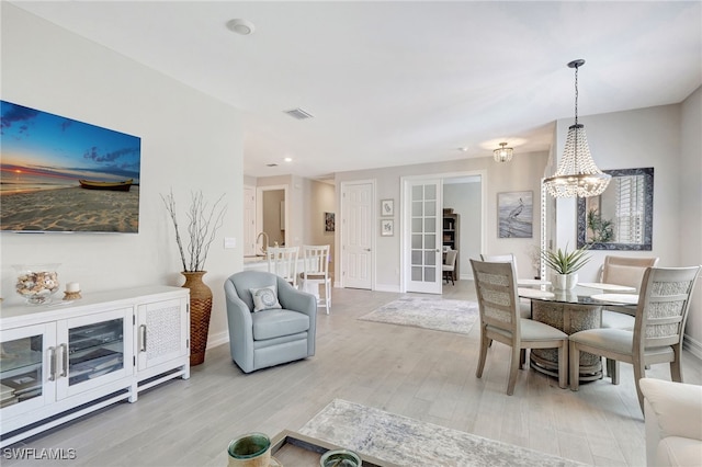 dining space featuring a chandelier and light hardwood / wood-style floors