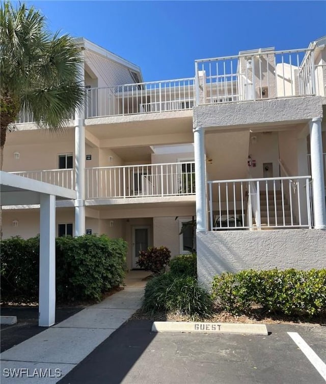 view of property featuring uncovered parking