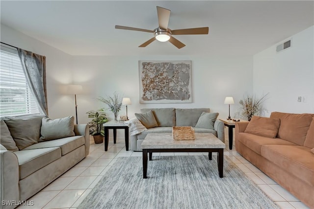 living room with light tile patterned floors, ceiling fan, and visible vents