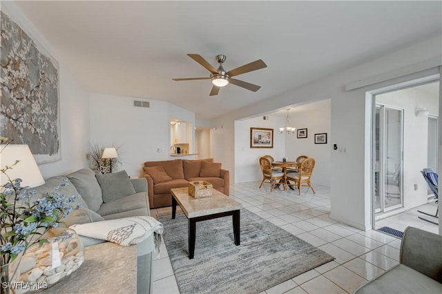 living room featuring light tile patterned floors, ceiling fan with notable chandelier, and visible vents