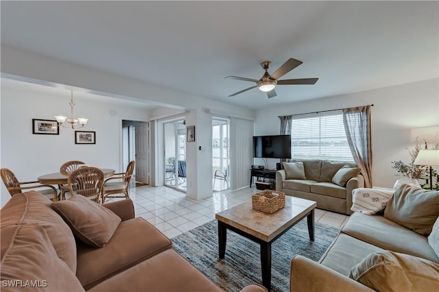 living area featuring ceiling fan with notable chandelier and light tile patterned floors