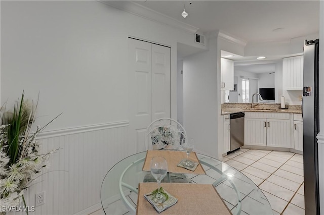 kitchen with light tile patterned floors, visible vents, stainless steel appliances, light countertops, and white cabinetry