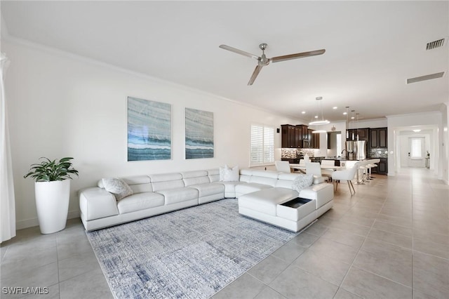 living room with light tile patterned floors, visible vents, ceiling fan, ornamental molding, and recessed lighting