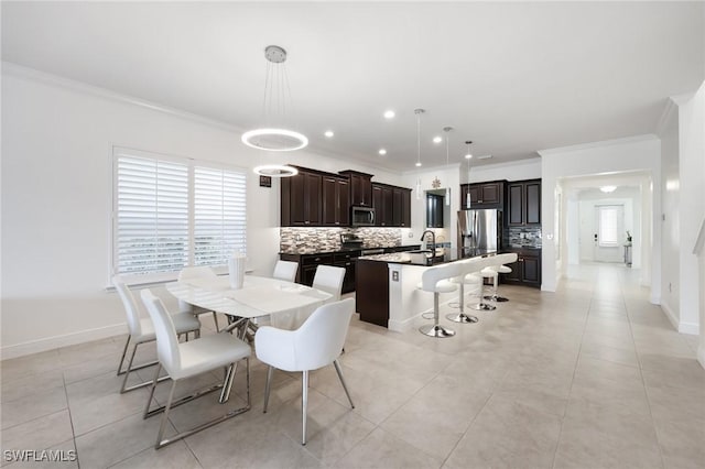 dining space featuring ornamental molding, baseboards, and light tile patterned floors