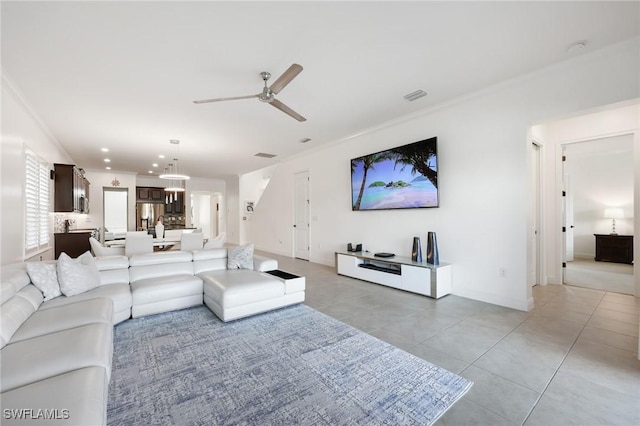 living room with light tile patterned floors, visible vents, ceiling fan, crown molding, and recessed lighting