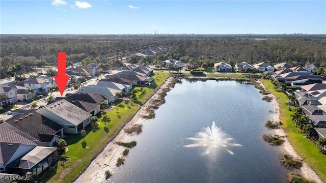 drone / aerial view with a residential view and a water view