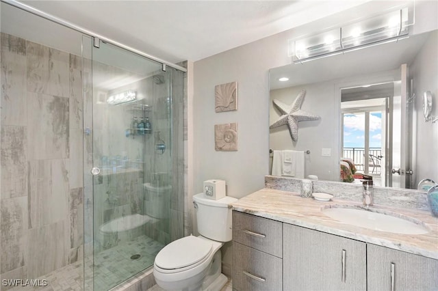 180 Seaview Ct Unit 911, Marco Island, FL 34145 - bathroom featuring toilet, a stall shower, and vanity