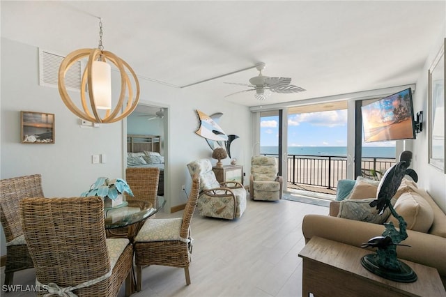 180 Seaview Ct Unit 911, Marco Island, FL 34145 - living room with ceiling fan and light wood finished floors