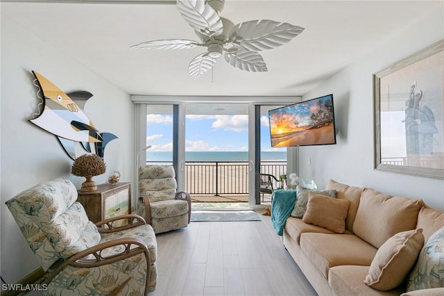 180 Seaview Ct Unit 911, Marco Island, FL 34145 - living area with expansive windows, healthy amount of natural light, ceiling fan, and wood finished floors