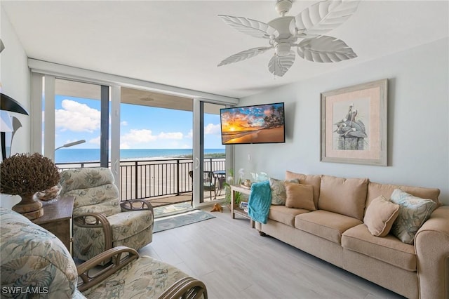180 Seaview Ct Unit 911, Marco Island, FL 34145 - living area featuring expansive windows, wood finished floors, and ceiling fan