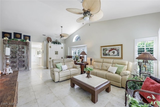 living area with ceiling fan, high vaulted ceiling, and light tile patterned flooring