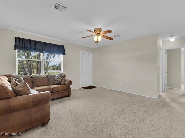 living room featuring light carpet, baseboards, visible vents, and a ceiling fan