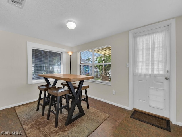 dining space featuring visible vents and baseboards