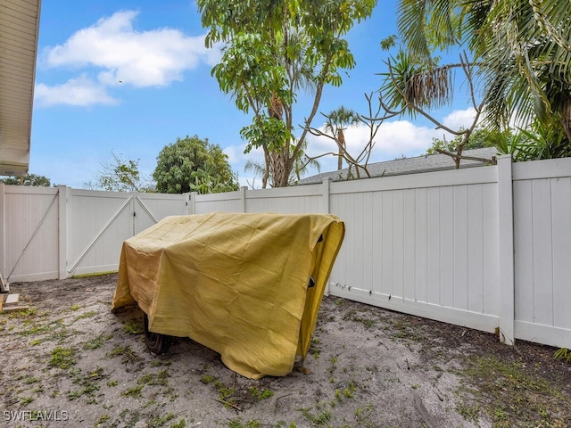 view of yard featuring a gate and a fenced backyard