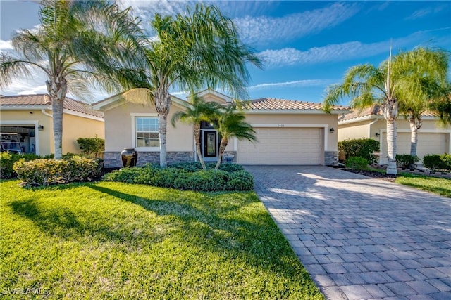 view of front of home with decorative driveway, stucco siding, a front yard, a garage, and stone siding